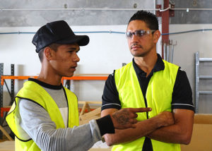 jarrad oakly nicholls with male program participant in high vis and safety glasses pointing
