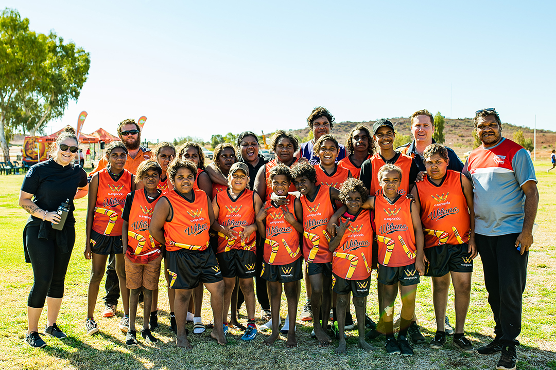wiluna rsas students in football uniforms standing in group